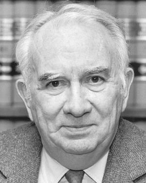 Harry Philo in front of a bookshelf